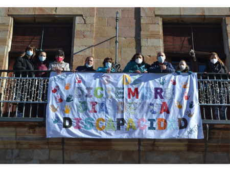 Amfisa cuelga una pancarta en el balc�n del Ayuntamiento por el D�a de la Discapacidad realizada por los chavales 